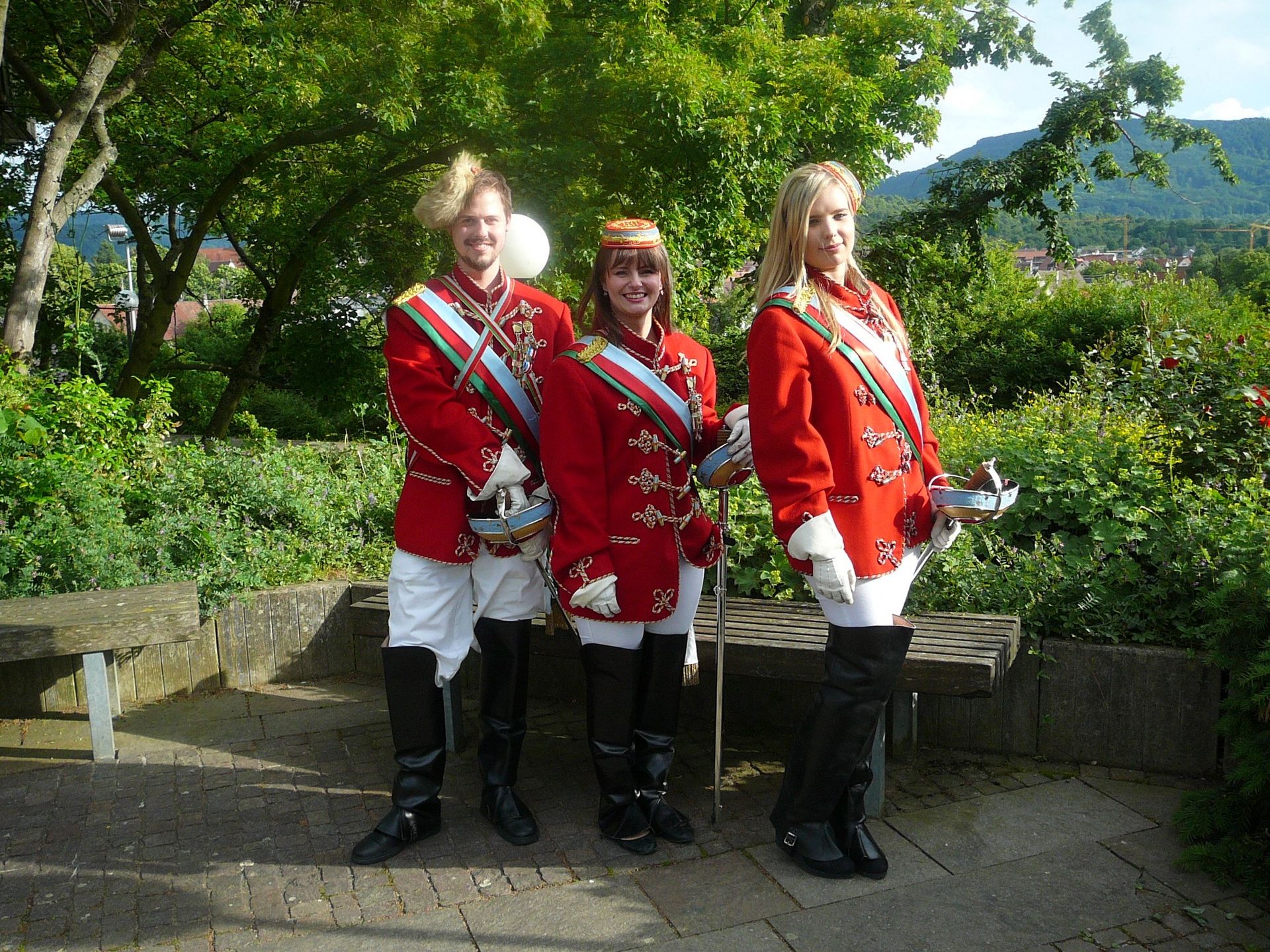 Three persons in red uniform
