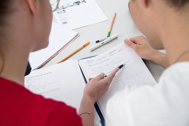 Two students work on a worksheet together