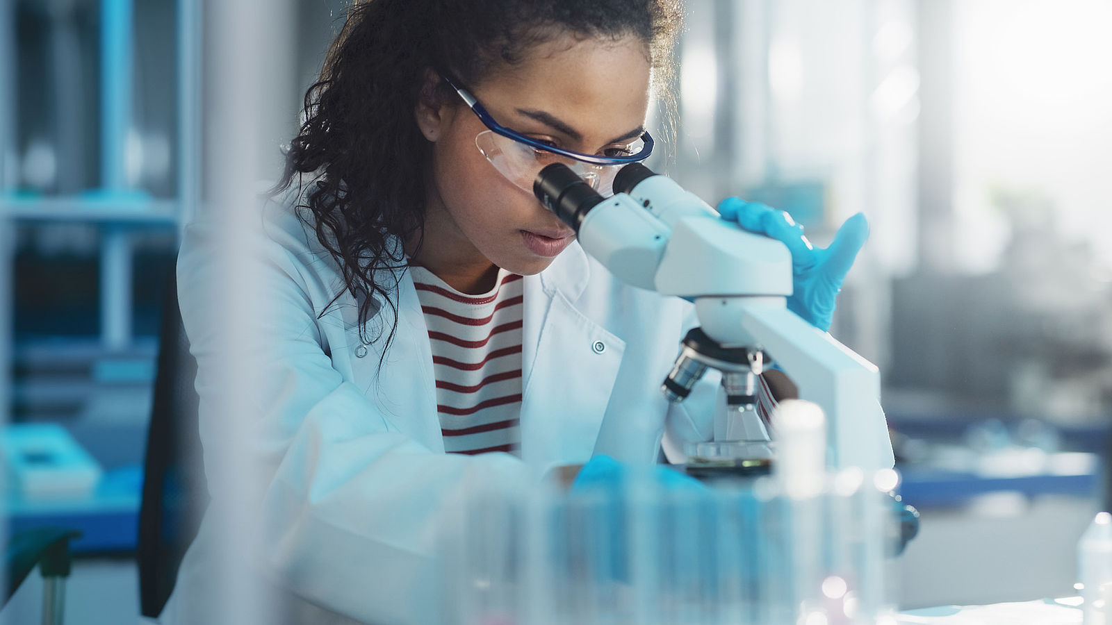 A scientist uses a microscope