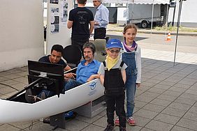 Two children in front of a canoe 