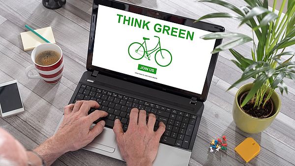 View of a laptop screen labeled Think Green