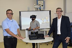 Zwei Männer mit Datenbrille und ein dritter Mann mit Virtual-Reality Kamera im Hintergrund