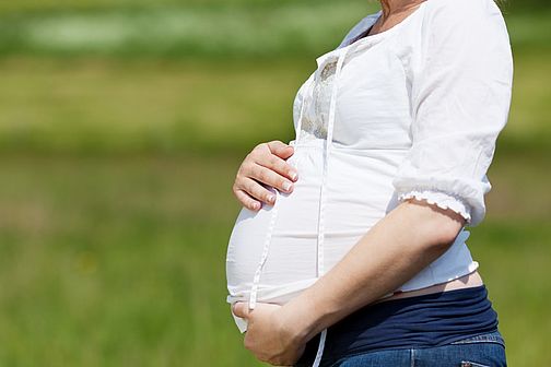 Pregnant woman holding her stomach