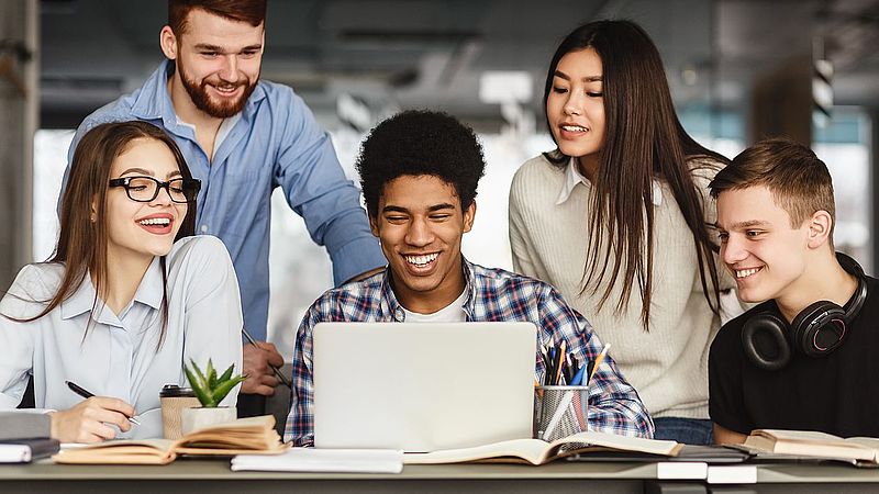 University students doing group project in library