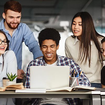 University students doing group project in library