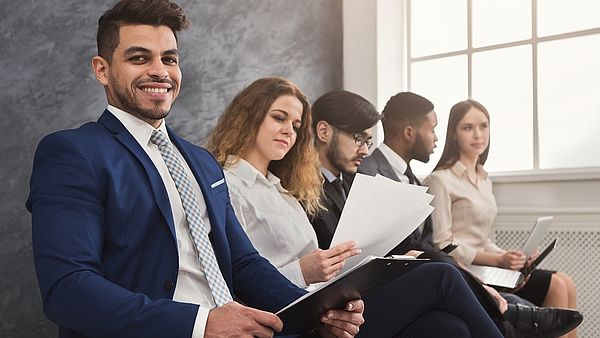 Multiracial people waiting in queue preparing for job interview