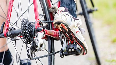 Person hat Fuß auf Fahrradpedal