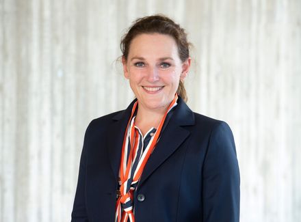 Eine elegant gekleidete Frau im Portrait.