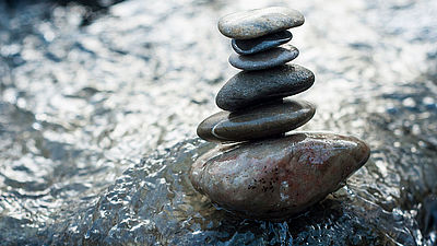 Closeup of stone balance on rocks in the river