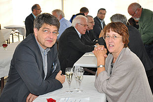 Man and woman sitting at a table in a marquee