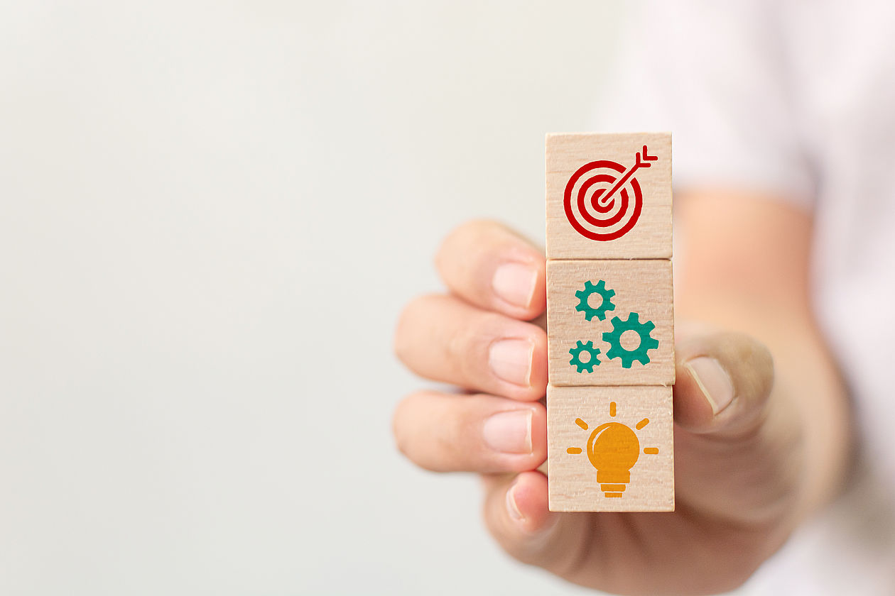 Concept of business strategy and action plan. Hand holding wood cube block stacking with icon Concept of business strategy and action plan. Hand holding wood cube block stacking with icon