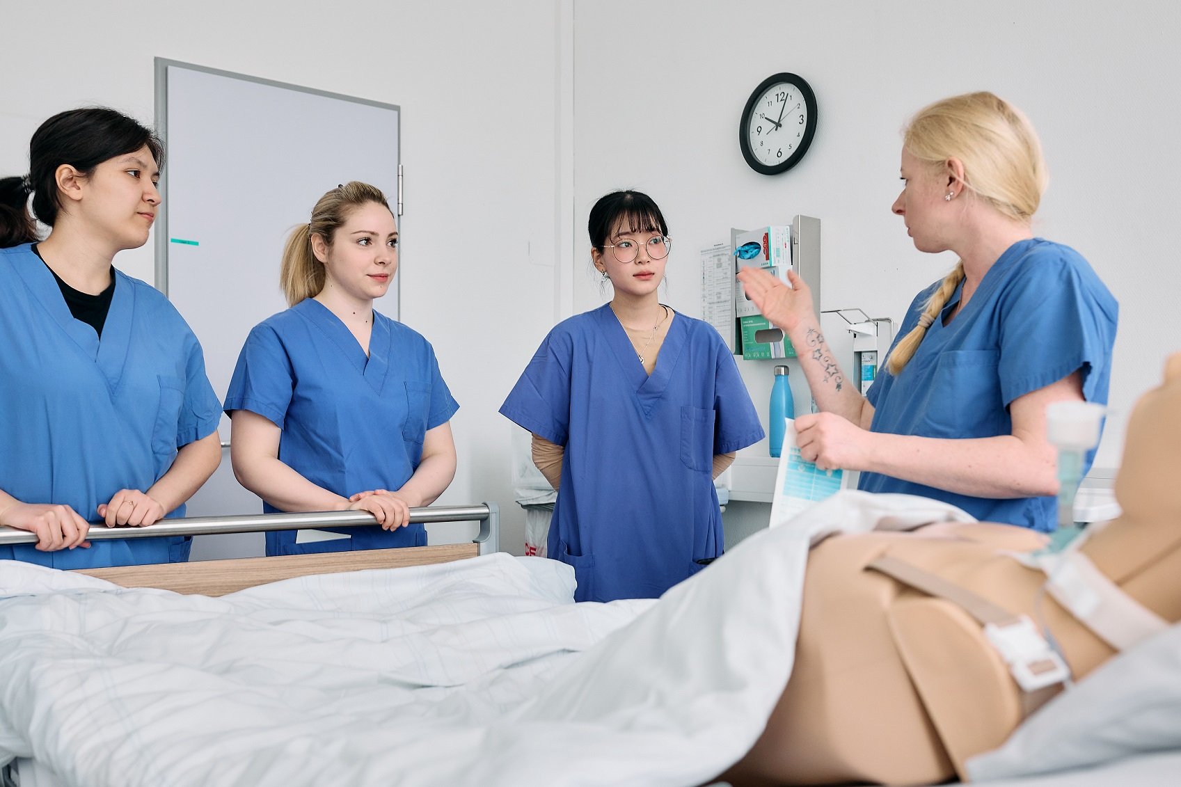 vier junge Frauen mit hellblauen Kitteln